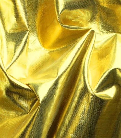 shiny gold metallic fabric|white fabric with gold accents.